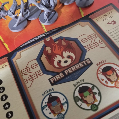 Miniatures above a turn card with a logo that says "Fire Ferrets" and has Korra, Bolin, Mako faces beneath it. "view"